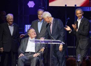 OLLEGE STATION, TX - OCTOBER 21: (L-R) Former United States Presidents Jimmy Carter, George H.W. Bush, George W. Bush, Bill Clinton, and Barack Obama address the audience during the 'Deep from the Heart: The One America Appeal Concert' at Reed Arena on the campus of Texas A&M University on October 21, 2017 in College Station, Texas. (Photo by Rick Kern/Getty Images for Ford Motor Company)