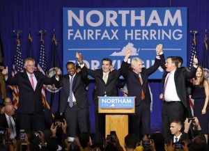 FAIRFAX, VA - NOVEMBER 07: Gov.-elect Ralph Northam (C) links arms with (L-R) current Gov. Terry McAuliffe, Lt. Gov.-elect Justin Fairfax, Attorney General-elect Mark Herring, and U.S. Sen. Mark Warner (D-VA) at an election night rally November 7, 2017 in Fairfax, Virginia. Northam defeated Republican candidate Ed Gillespie. (Photo by Win McNamee/Getty Images)