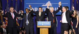 FAIRFAX, VA - NOVEMBER 07: Gov.-elect Ralph Northam (C) links arms with (L-R) current Gov. Terry McAuliffe, Lt. Gov.-elect Justin Fairfax, Attorney General-elect Mark Herring, and U.S. Sen. Mark Warner (D-VA) at an election night rally November 7, 2017 in Fairfax, Virginia. Northam defeated Republican candidate Ed Gillespie. (Photo by Win McNamee/Getty Images)