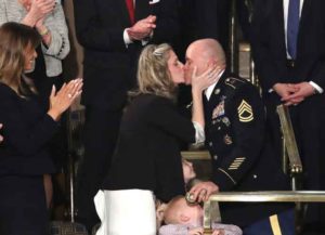 WASHINGTON, DC - FEBRUARY 04: Sgt. 1st Class Townsend Williams kisses his wife Amy after surprising his family by returning early from deployment in Afghanistan during the State of the Union address in the chamber of the U.S. House of Representatives on February 04, 2020 in Washington, DC.