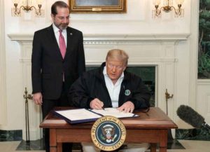Alex Azar watches President Trump sign Coronavirus Relief Act