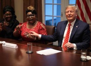 WASHINGTON, DC - FEBRUARY 27: U.S. President Donald Trump (C) jokes with guests (L-R) Lynette 'Diamond' Hardaway, Rochelle 'Silk' Richardson, Terrence Williams and Angela Stanton-King during a news conference and meeting in the Cabinet Room at the White House February 27, 2020 in Washington, DC.