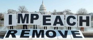 WASHINGTON, DC - JANUARY 12: People gather at the base of the U.S. Capitol with large IMPEACH and REMOVE letters on January 12, 2021 in Washington, DC. The group is calling on Congress to impeach and remove President Donald Trump on the day that Democrats introduced articles of impeachment in response to Trump's incitement of a mob entering the U.S. Capitol Building on January 6. (Photo by Paul Morigi/Getty Images for MoveOn)