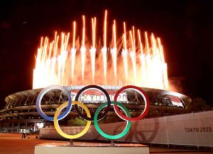 TOKYO, JAPAN - JULY 23: The Olympic Rings are seen outside the stadium as fireworks go off during the Opening Ceremony of the Tokyo 2020 Olympic Games at Olympic Stadium on July 23, 2021 in Tokyo, Japan. (Photo by Lintao Zhang/Getty Images)