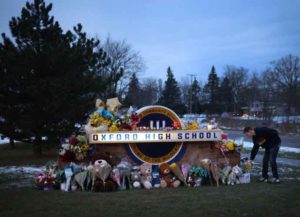 OXFORD, MICHIGAN - DECEMBER 01: People visit a makeshift memorial outside of Oxford High School on December 01, 2021 in Oxford, Michigan. Yesterday, four students were killed and seven injured when student Ethan Crumbley allegedly opened fire on fellow students at the school. (Photo by Scott Olson/Getty Images)