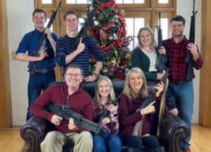 Thomas Massey and family hold assault rifles in Christmas card (Image: Twitter)