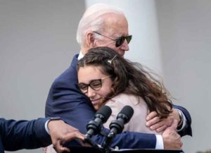 WASHINGTON, DC - APRIL 11: U.S. President Joe Biden hugs Mia Tretta, a Saugus High School shooting survivor, after she spoke during an event about gun violence in the Rose Garden of the White House April 11, 2022 in Washington, DC. Biden announced a new firearm regulation aimed at reining in ghost guns, untraceable, unregulated weapons made from kids. Biden also announced Steve Dettelbach as his nominee to lead the Bureau of Alcohol, Tobacco, Firearms and Explosives (ATF). (Photo by Drew Angerer/Getty Images)