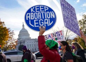 WASHINGTON, DC - DECEMBER 01: Participants hold signs during the Women's March "Hold The Line For Abortion Justice" at the U.S. Supreme Court on December 01, 2021 in Washington, DC. (Photo by Leigh Vogel/Getty Images for Women's March Inc)