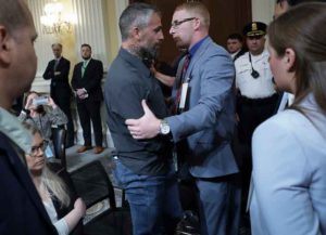 WASHINGTON, DC - JULY 12: Stephen Ayres (C), who entered the U.S. Capitol illegally on January 6, 2021, greets former Washington Metropolitan Police Officer Michael Fanone at the conclusion of the seventh hearing by the House Select Committee to Investigate the January 6th Attack on the U.S. Capitol in the Cannon House Office Building on July 12, 2022 in Washington, DC. The bipartisan committee, which has been gathering evidence for almost a year related to the January 6 attack at the U.S. Capitol, is presenting its findings in a series of televised hearings. On January 6, 2021, supporters of former President Donald Trump attacked the U.S. Capitol Building during an attempt to disrupt a congressional vote to confirm the electoral college win for President Joe Biden. (Photo by Kevin Dietsch/Getty Images)