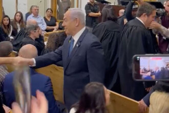 VIDEO: Israeli Prime Minister Netanyahu Greets Gallery In Packed Courtroom Ahead Of Taking Stand In Corruption Case