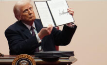 WASHINGTON, DC - JANUARY 20: U.S. President Donald Trump holds up an executive order after signing it during an indoor inauguration parade at Capital One Arena on January 20, 2025 in Washington, DC. Donald Trump takes office for his second term as the 47th president of the United States. (Photo by Christopher Furlong/Getty Images)