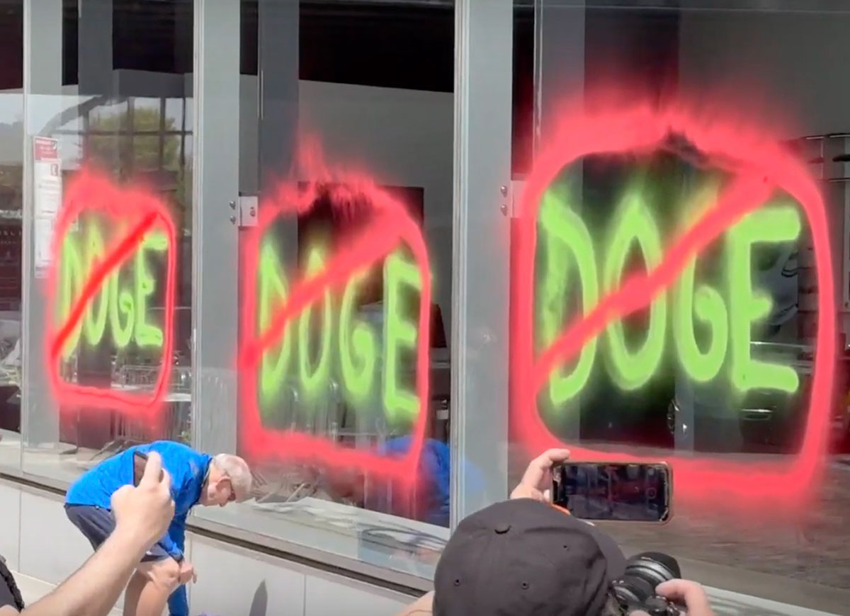 VIDEO: Climate Activists Spray Paint NYC Tesla Showroom On Earth Day