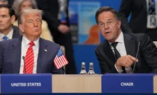 THE HAGUE, NETHERLANDS - JUNE 25: U.S. President Donald Trump (L) looks on as NATO General Secretary Mark Rutte (R) speaks during a North Atlantic Council plenary meeting at the NATO Summit on June 25, 2025 in The Hague, Netherlands. This year's NATO summit, which brings together heads of state and government from across the military alliance, is being held in the Netherlands for the first time. Among other matters, members are to approve a new defense investment plan that raises target for defense spending to 5% of GDP. (Photo by Andrew Harnik/Getty Images)